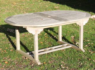 Lindsey, an oval well weathered teak slatted garden table with concealed extra leaf 75cm h x 181cm l x 120cm w 