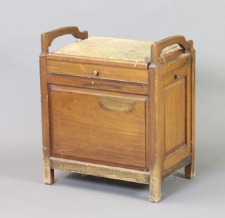 A mahogany piano stool with hinged lid, the side fitted a fall front 64cm h x 55cm w x 36cm d (upholstery to the seat requires attention) 