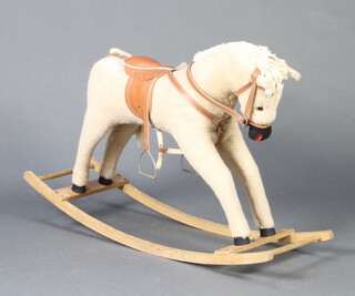 A plush rocking horse with leather accessories and glass eyes 68cm h x 106cm l x 30cm w