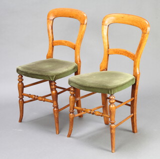 A pair of Victorian mahogany bar back bedroom chairs with plain mid rails and over stuffed seats, raised on turned supports