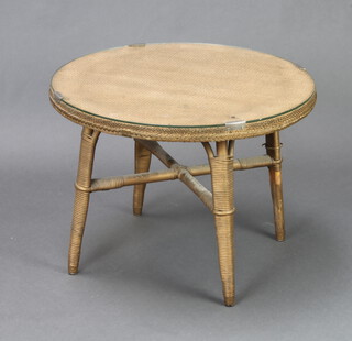 A circular gold painted painted loom style occasional table with plate glass top raised on outstretched supports 45cm h x 61cm diam. 
