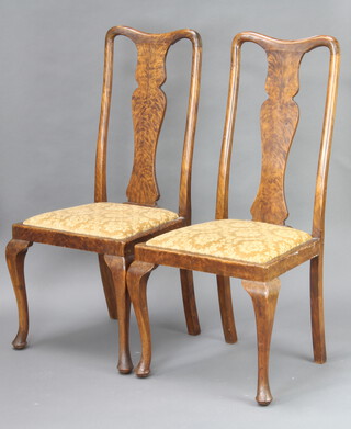 A pair of simulated figured walnut Queen Anne style slat back dining chairs with upholstered drop in seats, raised on cabriole supports 
