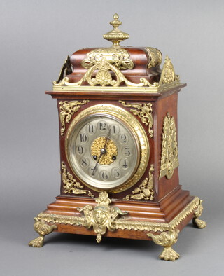 A 19th Century French 8 day striking bracket clock with silvered dial and Arabic numerals, contained in a walnut and gilt metal mounted case, raised on paw feet complete with pendulum and key 