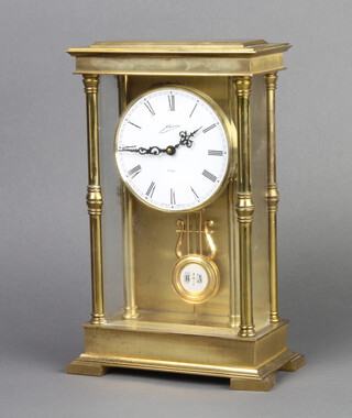A German 9 day striking 4 glass clock with enamelled dial and Roman numerals contained in a gilt metal case 