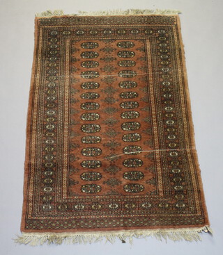 A pink and white ground Bokhara rug with 28 octagons to the centre within a multi row border 152cm x 94cm 