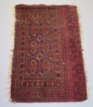 A red ground Bokhara rug with 6 octagons within a multi row border 140cm x 87cm  