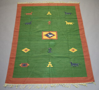 A green and tan ground Kilim rug with stylised decoration 203cm x 150cm

