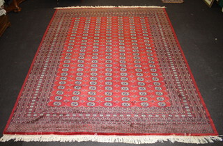 A red ground Bokhara carpet with numerous octagons to the centre within a multi row border 368cm x 281cm 