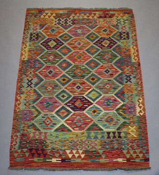 A yellow, turquoise and green ground Chobi Kilim rug with all over geometric design 182cm x 121cm 