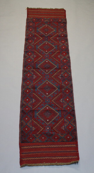 A red and green ground Meshwani runner with 5 octagons to the centre 240cm x 58cm 