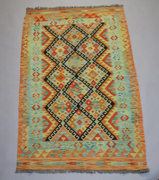 A yellow and green ground Chobi Kilim with all over geometric designs 170cm x 106cm 