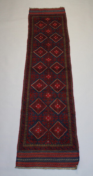 A red and blue ground Meshwani runner with 14 stylised diamonds to the centre within a multi row border 265cm x 61cm 