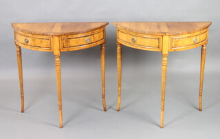 A pair of Georgian style inlaid and crossbanded yew demi-lune tables fitted dummy drawer, raised on turned and fluted supports 76cm h x 77cm w x 33cm d 