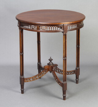 A circular Chippendale style mahogany occasional table with pierced fret and X framed stretcher, raised on turned supports 68cm h x 59cm w