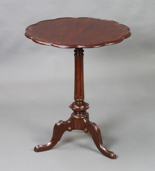 A 19th/20th Century circular Chippendale style mahogany wine table with shaped top, raised on a turned and fluted column, tripod base 70cm h x 59cm diam. 