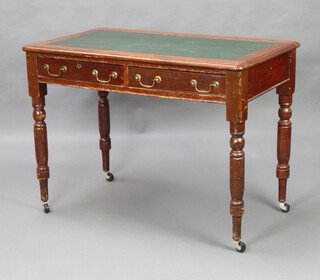 A Victorian mahogany writing table with inset writing surface above 2 long drawers with brass swan neck drop handles, raised on turned supports and later casters 76cm h x 105cm w x 61cm d 
