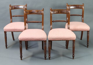 A set of 4 Georgian mahogany bar back dining chairs with carved rope mid rails and over stuffed seats, raised on turned supports 