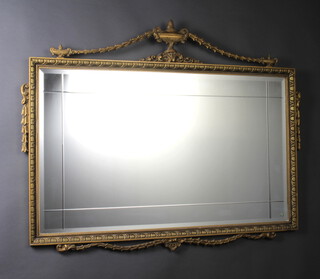 A Georgian style rectangular bevelled plate and cut glass mirror contained in a gilt frame surmounted by a lidded urn with swag decoration 76cm h x 97cm 