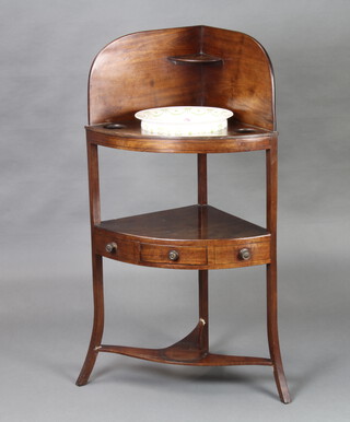 A Georgian mahogany corner wash stand with 3/4 gallery, 3 bowl receptacles, undertier fitted a drawer flanked by 2 dummy drawers, 108cm h x 42cm w x 42cm d, fitted with an associated pottery bowl  
