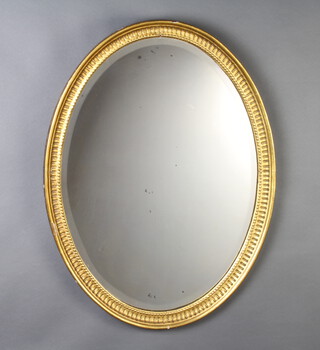 A 19th Century oval bevelled plate wall mirror contained in a decorative gilt frame 69cm h x 51cm w 