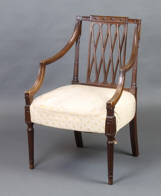 A Georgian style mahogany open armchair with trellis work back, raised on turned and fluted supports 