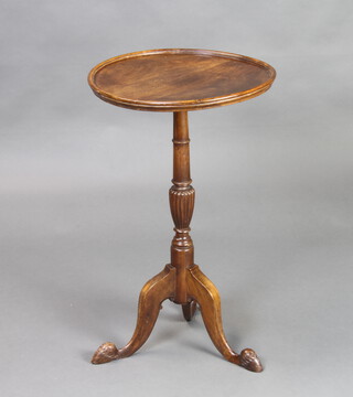 A Georgian style circular mahogany wine table raised on pillar and tripod base with hoof feet 66cm h x 42cm diam. 