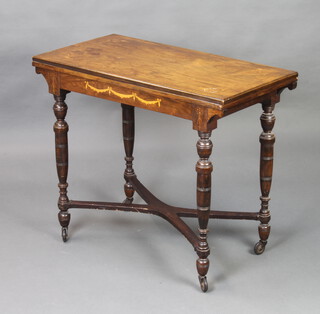 A Victorian rectangular inlaid rosewood card table, raised on turned supports with X framed stretcher and later casters 70cm h x 85cm w x 43cm d 
