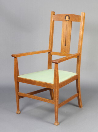 An Edwardian Art Nouveau Liberty style inlaid oak slat back carver chair with upholstered seat, raised on square tapered supports