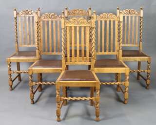 A set of 6 1930's bleached oak stick and rail back dining chairs with spiral turned decoration and upholstered drop in seats, raised on turned and block supports 