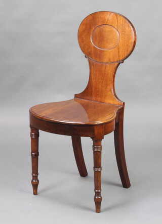 A Georgian mahogany hall chair with oval back and shaped seat raised on turned supports 