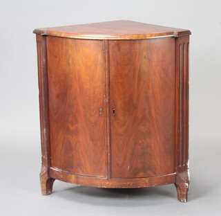 A 19th Century Continental mahogany bow front corner cabinet with canted and fluted corners 82cm h x 53cm w x 51cm d 