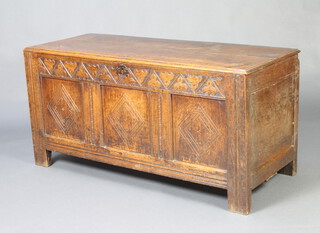 A 17th/18th Century carved oak coffer of panelled construction with hinged lid, possible replacement metal hinges and steel lock 65cm h x 135cm w x 53cm d 