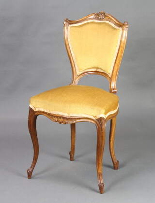 A 19th Century French carved walnut show frame chair, the seat and back upholstered in mustard coloured material 