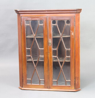 A 19th Century mahogany hanging corner cabinet with moulded cornice enclosed by by astragal glazed panelled door 89cm h x 50cm w x 42cm d 