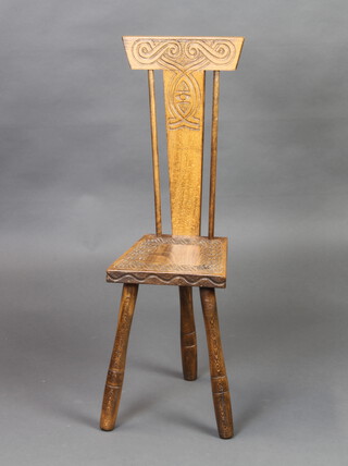 Ben Setter of Totnes, a carved oak spinning chair with solid seat raised on 3 turned supports 