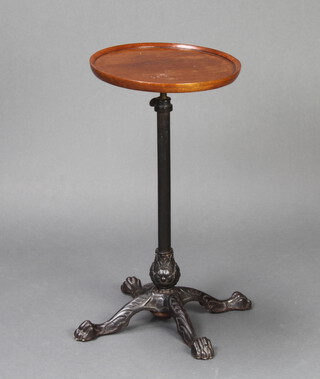 A Victorian wrought iron and turned mahogany dish top adjustable wine table raised on an iron stand with paw feet 65cm h x 34cm diam. 