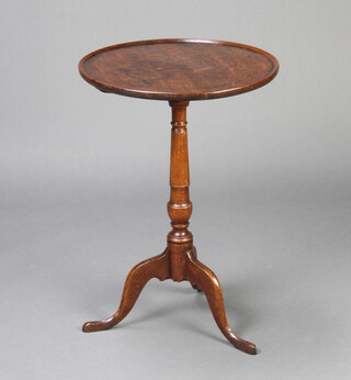 A Georgian circular oak wine table with dish top raised on turned and tripod supports 70cm h x 49cm d 
