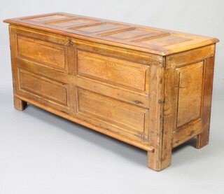 An 18th/19th Century inlaid oak coffer of panelled construction with hinged lid 68cm h x 149cm w x 52cm d 