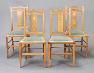 A set of 4 Art Nouveau Liberty style inlaid oak slat back bedroom chairs, raised on square tapered supports 