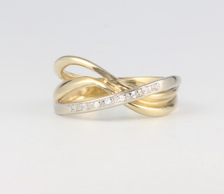 A 14ct 2 colour gold and diamond crossover ring 3.5 grams, size N 1/2