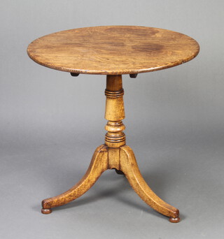 A Georgian circular oak snap top tea table, raised on turned column and tripod base, bun feet, 68cm h x 67cm diam.