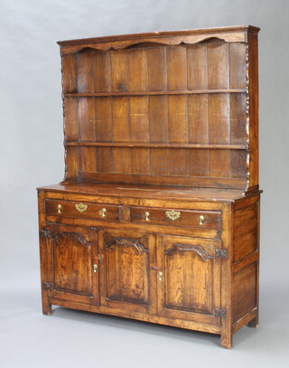 A Georgian style oak dresser, the raised back fitted 2 shelves above recess, the base with 2 long drawers above double cupboard, having arcaded decoration 176cm h x 136cm w x 42cm d 