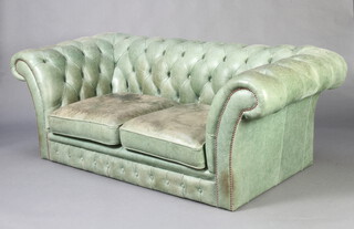 A 2 seat Chesterfield upholstered in green buttoned material 64cm h x 183cm w x 87cm d 