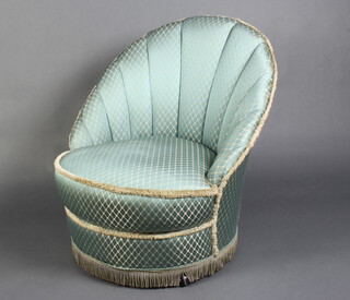 A 1950's cloud back tub back armchair, upholstered in blue material 