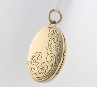 A 9ct yellow gold oval locket with engraved decoration 35mm, 3.6 grams