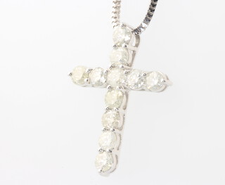 A 14 white gold diamond set cross pendant on a silver chain, diamonds approx. 2.20ct, 4.7 grams 