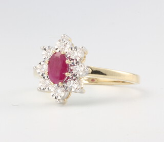 A 9ct yellow gold oval ruby and diamond cluster ring, the ruby approx. 0.57ct, diamonds 0.10ct, size N, 2.7 grams