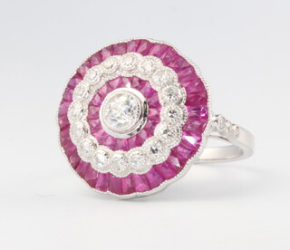 An Edwardian style platinum, ruby and diamond ring, the centre old cut diamond surrounded by diamonds and outer ring of rubies, diamonds approx. 1.ct, rubies 2.95, size N 1/2, 5.4 grams 