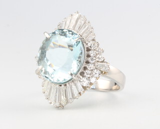 A platinum aquamarine and diamond cocktail ring, the centre stone 8.99ct the brilliant and tapered baguette cut diamonds approx. 1.95ct, size N, 13.1 grams