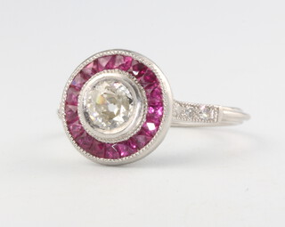 A platinum and mine cut diamond and ruby Art Deco style ring, diamond approx. 0.5ct, surrounded by calibre cut rubies approx 0.4ct having diamond shoulders approx. 0.12ct, size O 1/2, 4.6 grams